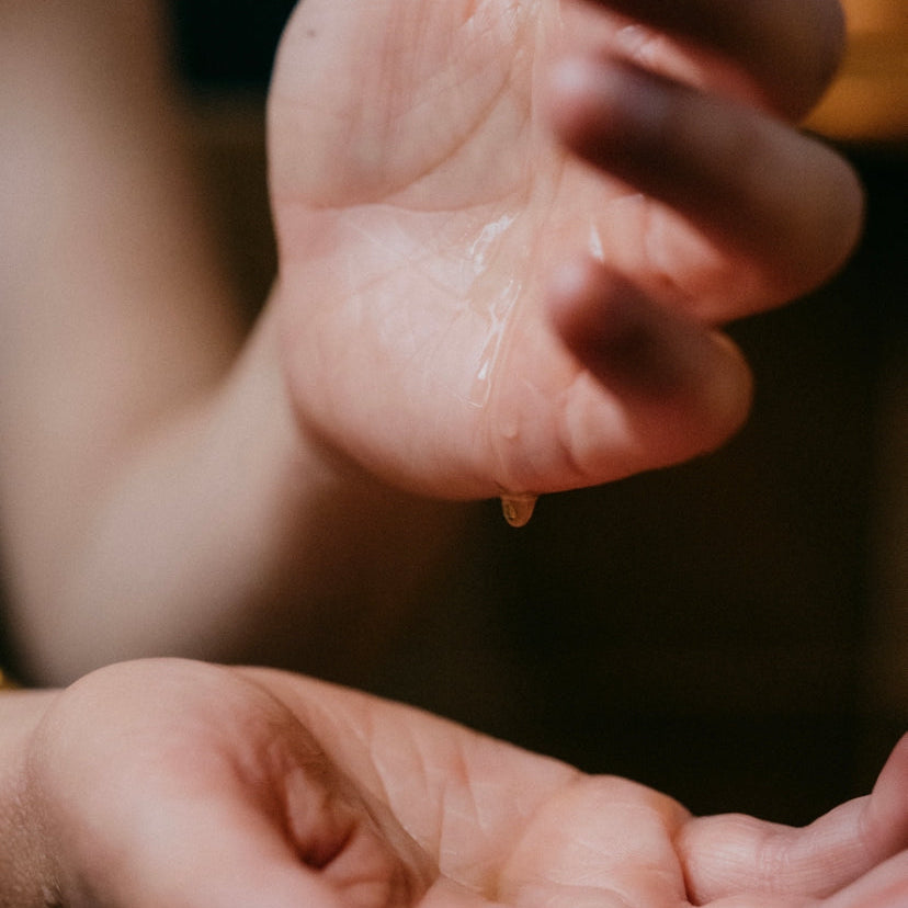 oil in hands, using nourishing facial serum